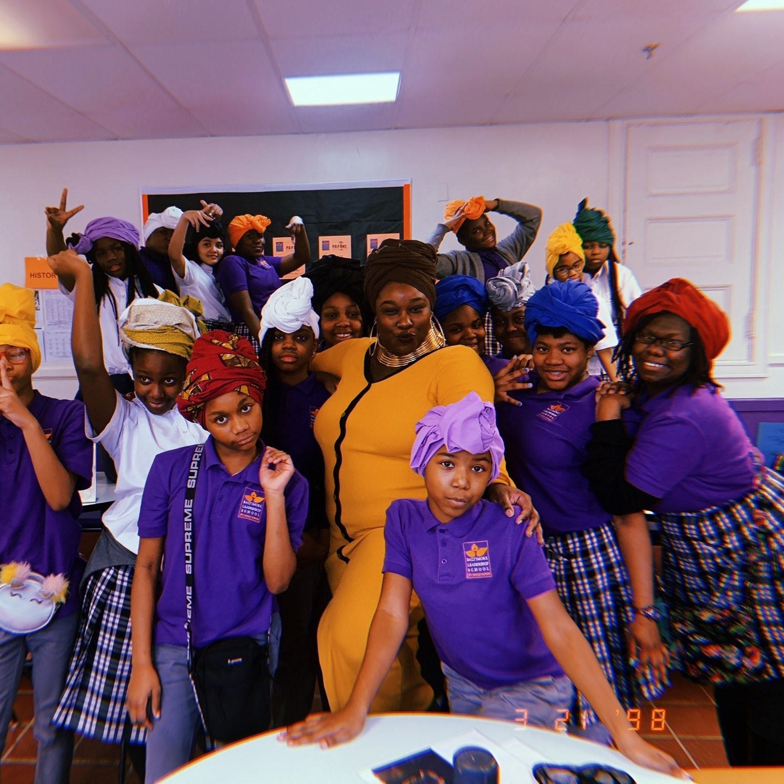 Baltimore Leadership School for Young Women learn how to wear head wraps at a workshop curated by Education Specialist, Ebony Evans