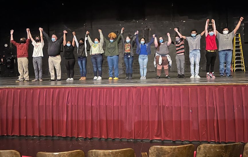 Community School students on stage after doing warm-ups with the Lyric Education team.png